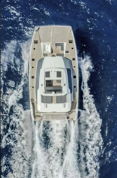 Slide: The Image of Aerial view of 2025 Fountaine Pajot Power 67 yacht cruising on open sea. - 36