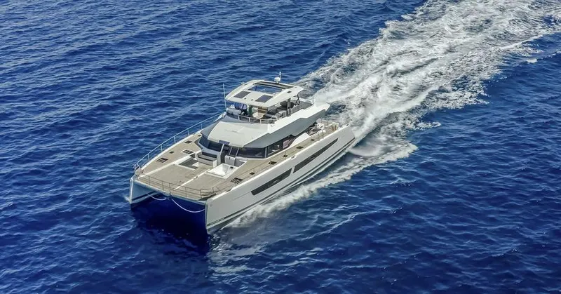 Slide: The Image of 2025 Fountaine Pajot Power 67 yacht cruising on open blue sea. - 37
