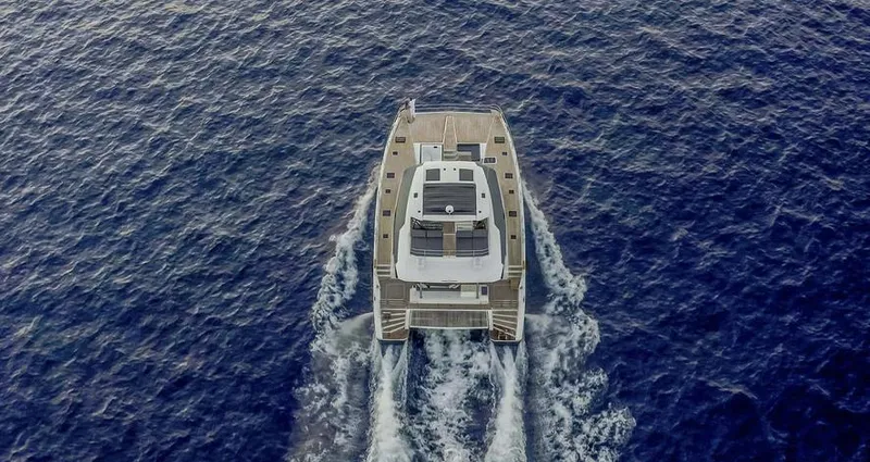 Slide: The Image of Aerial view of 2025 Fountaine Pajot Power 67 yacht cruising on open sea. - 38