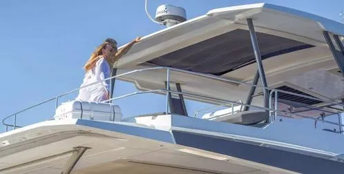 Slide: The Image of Woman on Fountaine Pajot Power 67 yacht, 2025 model, enjoying the upper deck. - 5