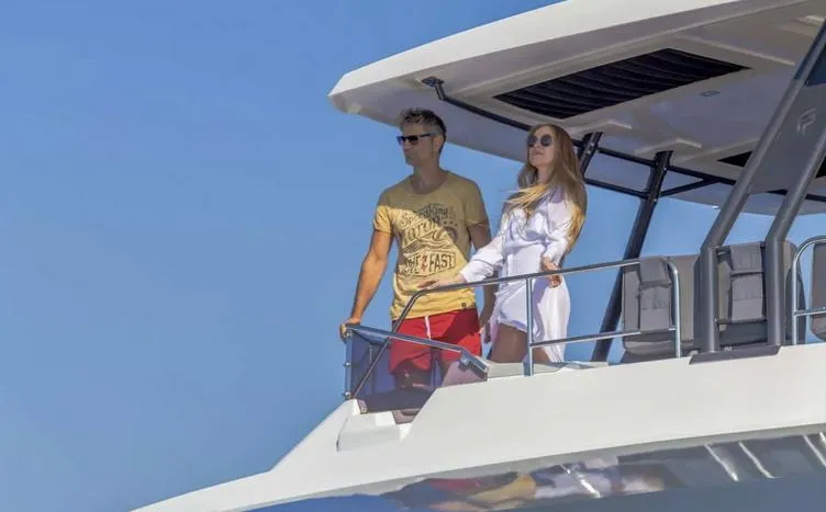 Slide: The Image of Couple enjoying the view on a 2025 Fountaine Pajot Power 67 yacht deck. - 6