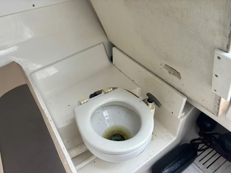 Slide: The Image of 2008 Angler 204WA boat interior with marine toilet. - 12