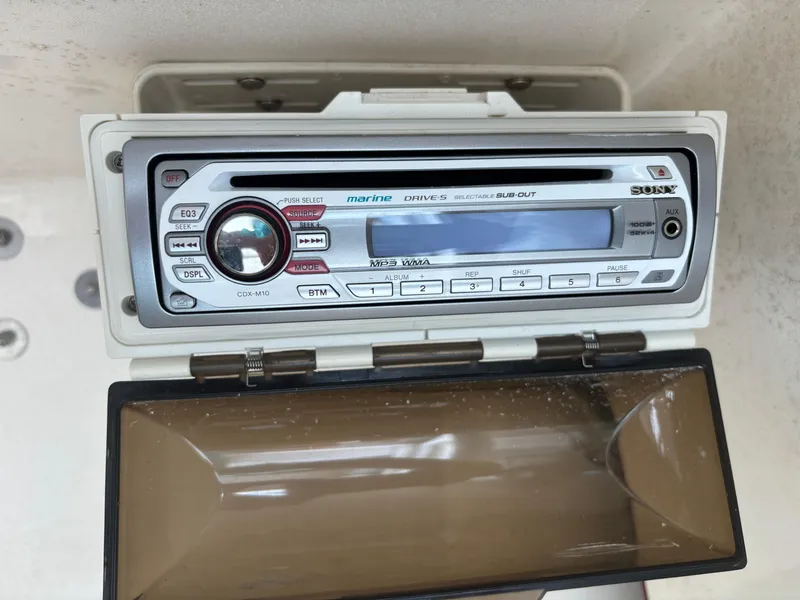 Slide: The Image of Marine stereo system in a 2008 Angler 204WA boat, featuring a protective cover. - 14