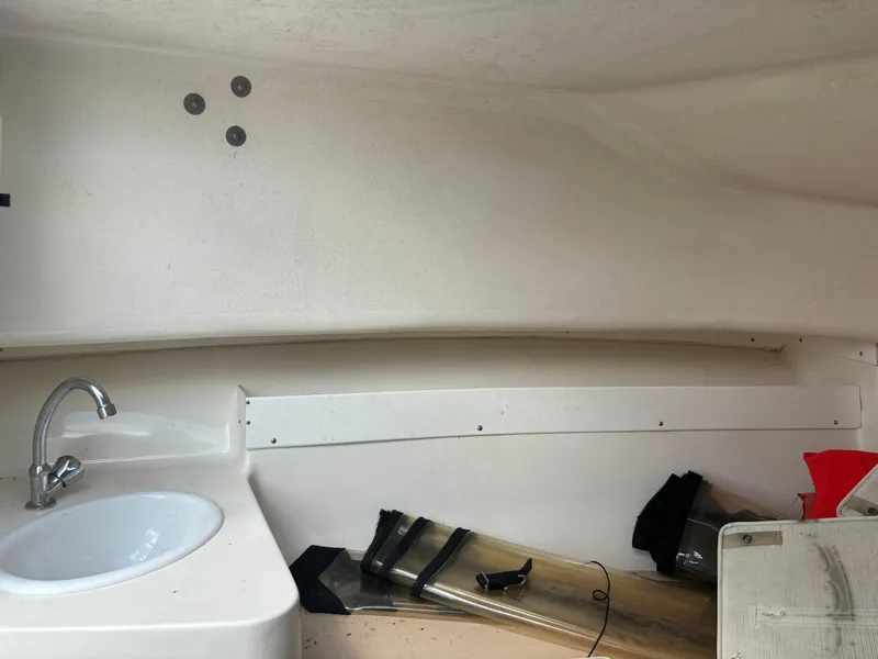 Slide: The Image of 2008 Angler 204WA boat interior with sink and storage area. - 16