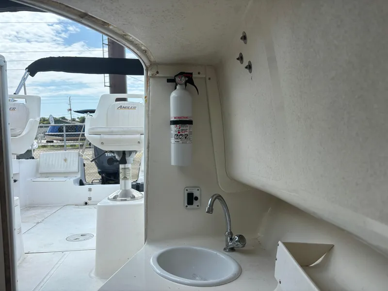 Slide: The Image of 2008 Angler 204WA boat interior with sink and fire extinguisher. - 19