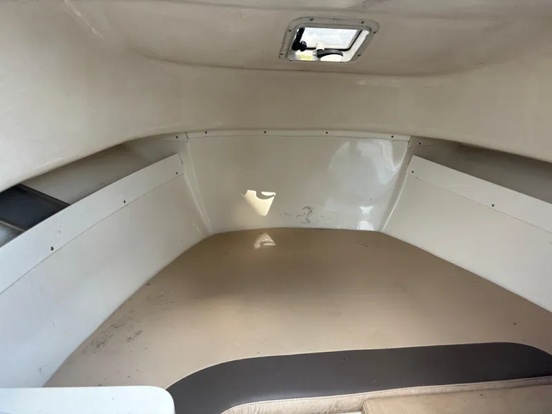 Slide: The Image of 2008 Angler 204WA boat cabin interior with hatch window. - 2
