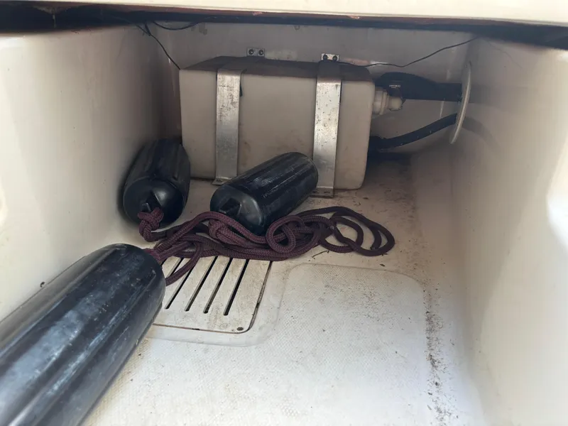 Slide: The Image of 2008 Angler 204WA boat storage compartment with fenders and ropes. - 20