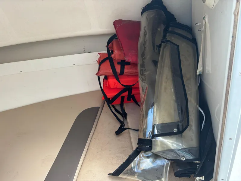 Slide: The Image of Storage area in 2008 Angler 204WA boat with life jackets and equipment. - 22