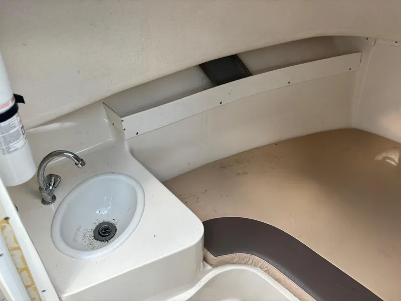 Slide: The Image of 2008 Angler 204WA boat interior with sink and seating area. - 23