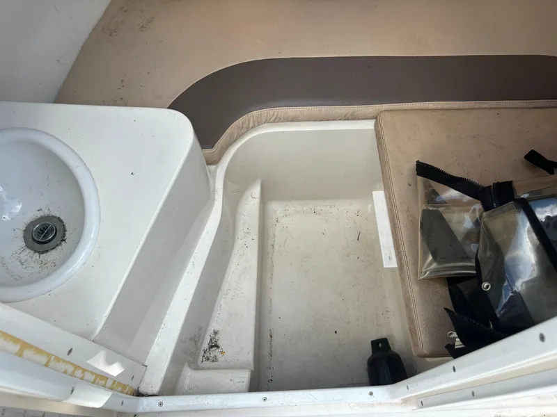 Slide: The Image of 2008 Angler 204WA boat interior with sink and seating area. - 24