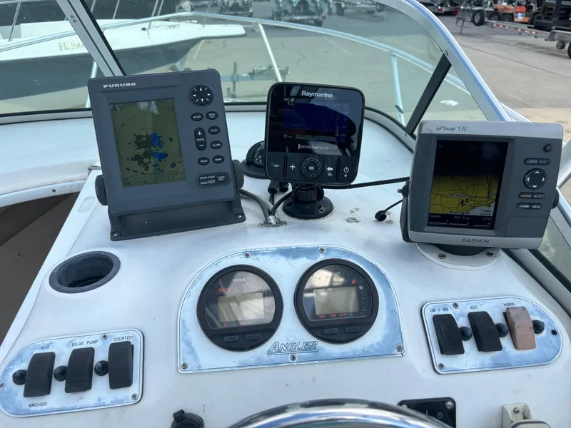 Slide: The Image of Dashboard of a 2008 Angler 204WA boat with navigation and control instruments. - 30