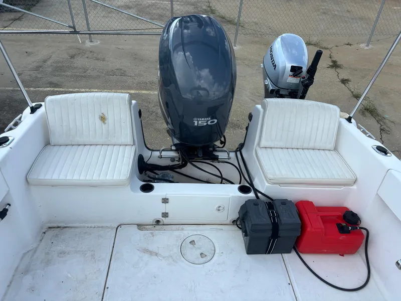 Slide: The Image of 2008 Angler 204WA boat with dual engines and seating, docked on concrete surface. - 37