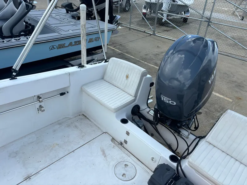 Slide: The Image of 2008 Angler 204WA boat with Yamaha 150 outboard motor, white seating, and docked at marina. - 38