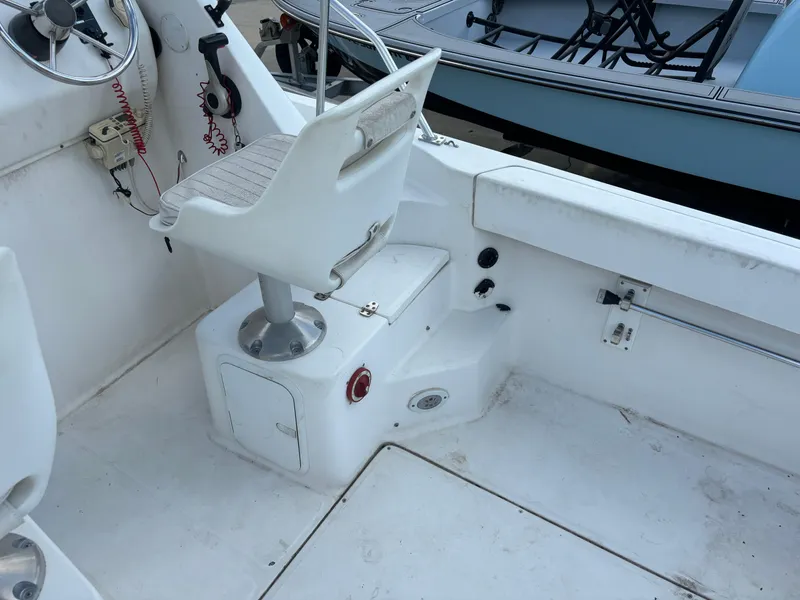 Slide: The Image of 2008 Angler 204WA boat interior with white captain's chair and steering wheel. - 39