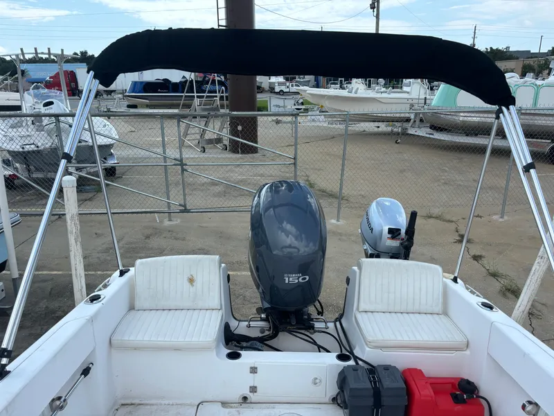 Slide: The Image of 2008 Angler 204WA boat with Yamaha 150 outboard motor, docked in a marina. - 4