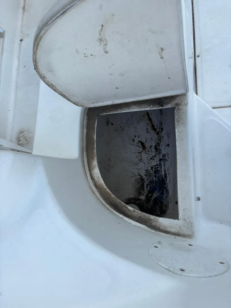 Slide: The Image of Open storage compartment on a 2008 Angler 204WA boat, showing interior details. - 40