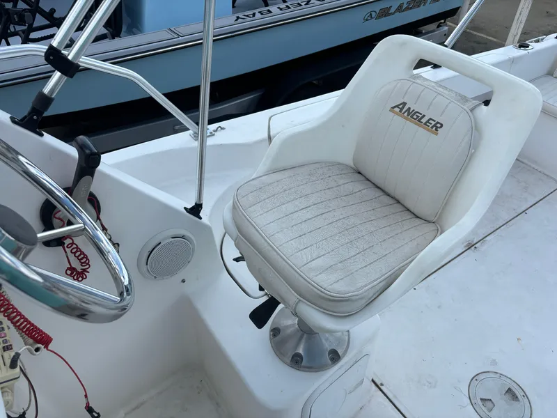 Slide: The Image of 2008 Angler 204WA boat captain's chair and steering wheel. - 47