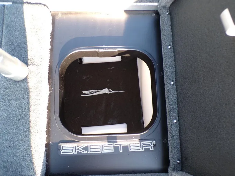 Slide: The Image of 2025 Skeeter FXR20L boat storage compartment with logo. - 26