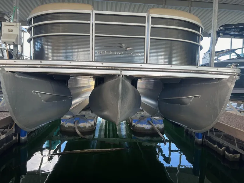 Slide: The Image of 2012 Bennington 25 RCW pontoon boat docked in a marina. - 1