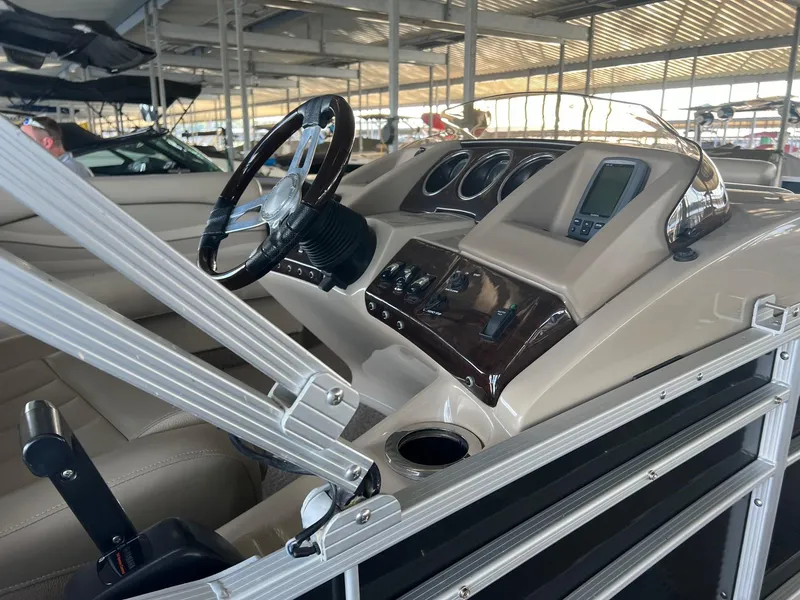 Slide: The Image of 2012 Bennington 25 RCW boat dashboard with steering wheel and control panel. - 10