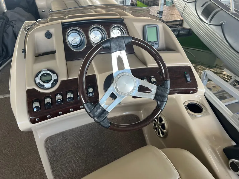 Slide: The Image of Steering console of a 2012 Bennington 25 RCW boat with gauges and controls. - 11