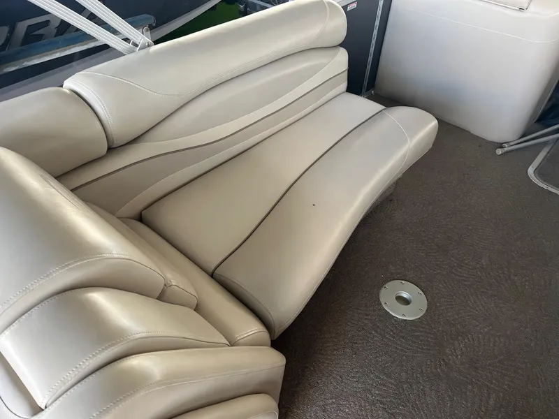 Slide: The Image of Luxurious seating on a 2012 Bennington 25 RCW boat, featuring beige upholstery. - 14