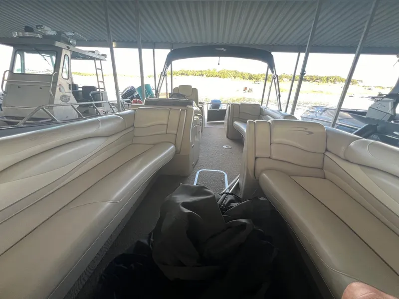 Slide: The Image of Interior view of a 2012 Bennington 25 RCW pontoon boat with beige seating. - 16