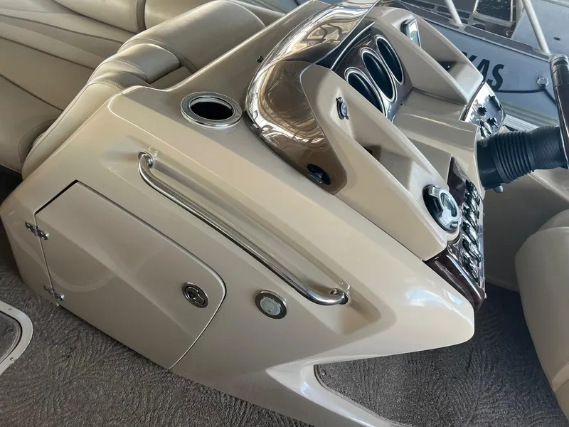 Slide: The Image of 2012 Bennington 25 RCW boat console with beige interior and control panel. - 18