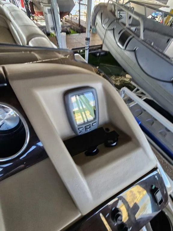 Slide: The Image of 2012 Bennington 25 RCW boat dashboard with navigation display and controls. - 20