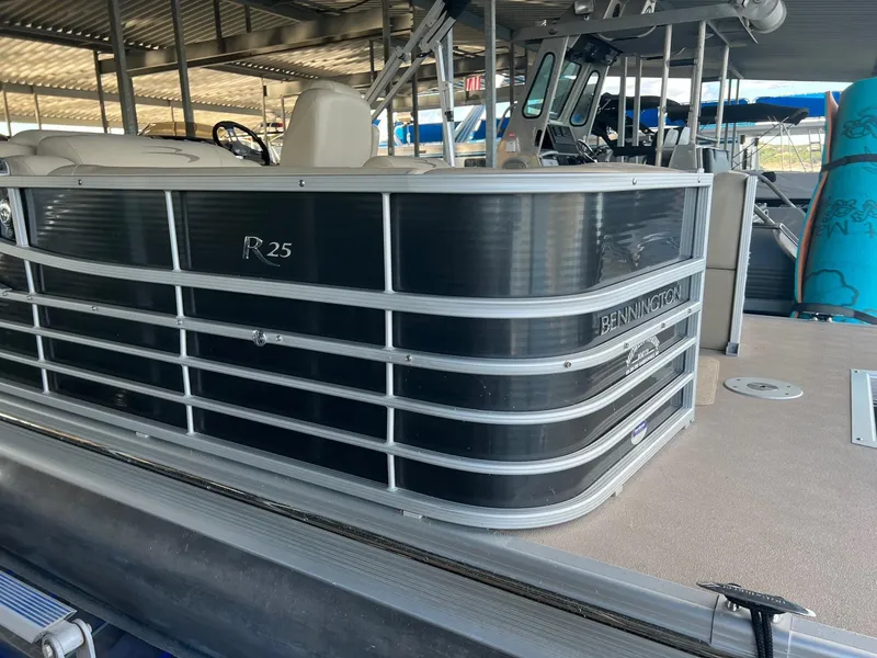 Slide: The Image of 2012 Bennington 25 RCW pontoon boat docked under a covered marina. - 4