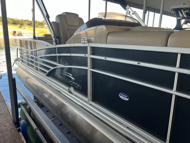 Slide: The Image of 2012 Bennington 25 RCW pontoon boat docked, featuring sleek design and comfortable seating. - 5