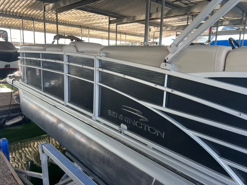 Slide: The Image of 2012 Bennington 25 RCW pontoon boat docked under a covered marina. - 6