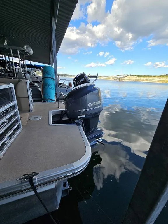 Slide: The Image of 2012 Bennington 25 RCW pontoon boat with Yamaha motor on a calm lake. - 8