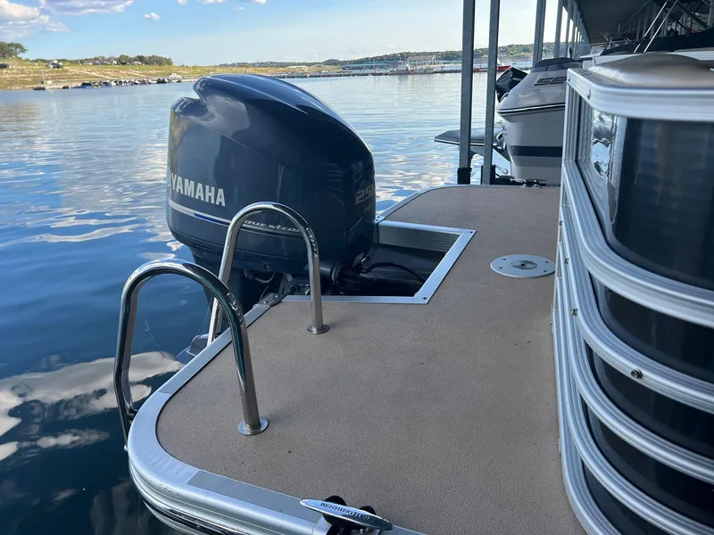 Slide: The Image of 2012 Bennington 25 RCW pontoon boat with Yamaha outboard motor on a calm lake. - 9