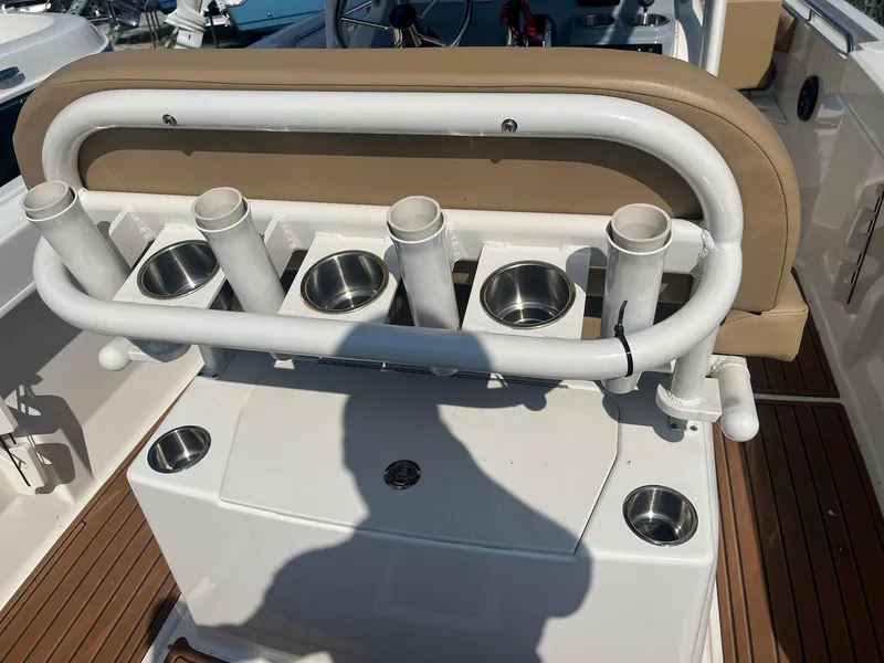 Slide: The Image of 2025 Bayliner Trophy T22CC boat with rod holders and cup holders on deck. - 11