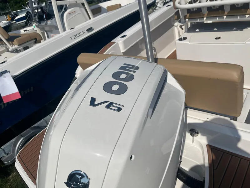 Slide: The Image of 2025 Bayliner Trophy T22CC boat with 200 V6 engine, beige seating, and sleek design. - 7