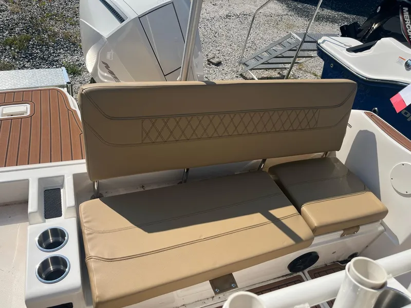 Slide: The Image of 2025 Bayliner Trophy T22CC boat with tan seating and dual cup holders. - 9