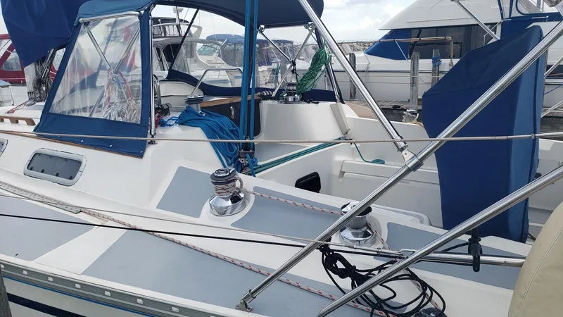 Slide: The Image of 1989 Hunter Legend 37 sailboat docked, featuring blue canvas covers and stainless steel rigging. - 10