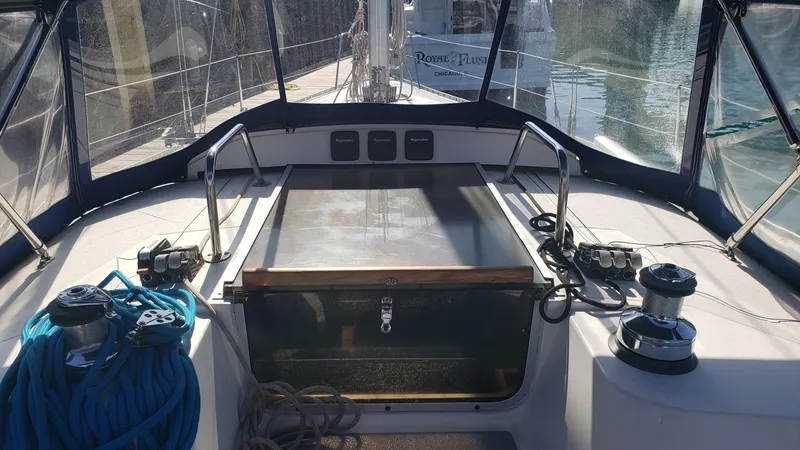 Slide: The Image of 1989 Hunter Legend 37 sailboat cockpit with ropes and winches, docked in sunlight. - 14