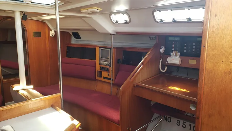 Slide: The Image of Interior of 1989 Hunter Legend 37 sailboat with wood finish and red seating. - 15