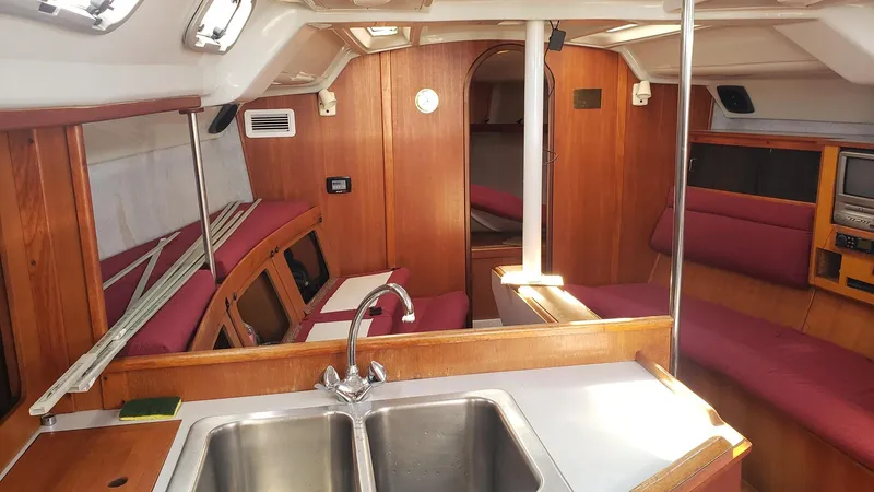 Slide: The Image of Interior of 1989 Hunter Legend 37 sailboat with wood finish and red seating. - 16