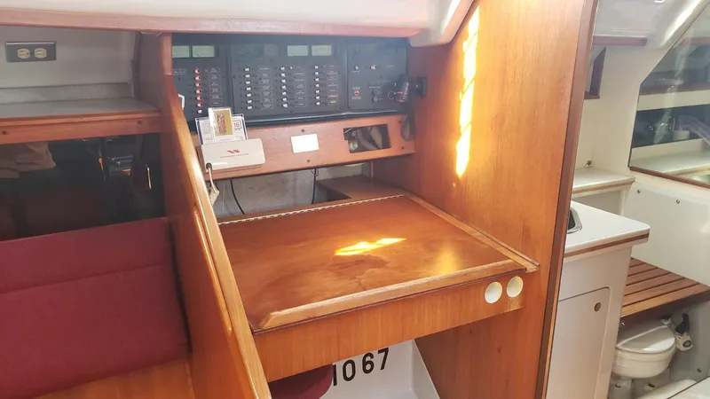 Slide: The Image of 1989 Hunter Legend 37 yacht interior with navigation station and control panel. - 21