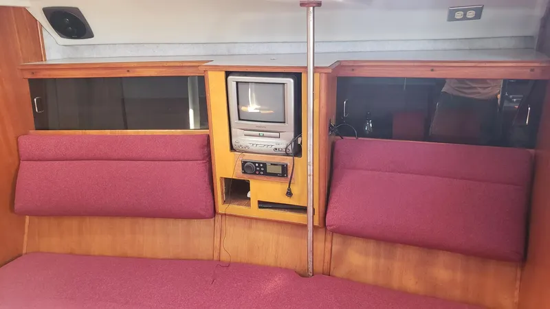 Slide: The Image of Interior of 1989 Hunter Legend 37 yacht with vintage TV and red seating. - 22