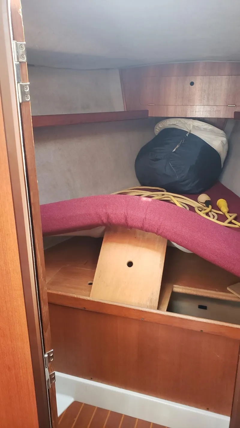 Slide: The Image of Interior cabin of 1989 Hunter Legend 37 sailboat with storage and cushions. - 24