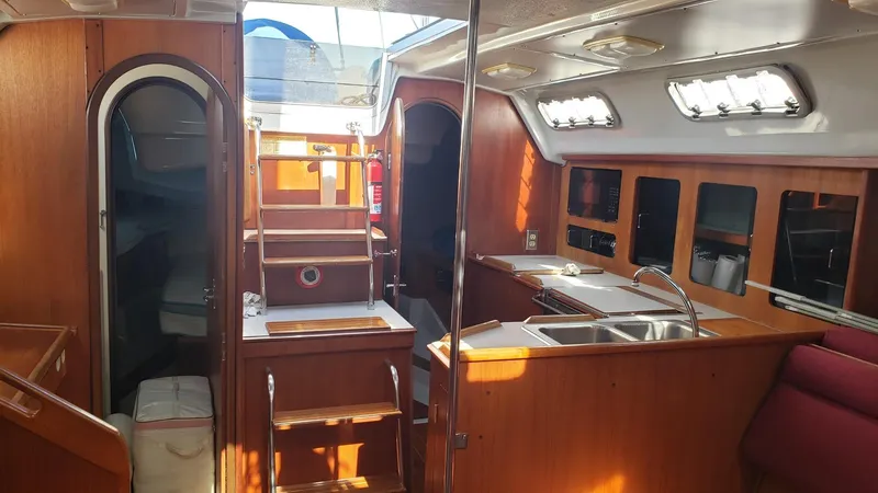 Slide: The Image of Interior of 1989 Hunter Legend 37 sailboat with wooden cabinetry and stainless steel sink. - 26