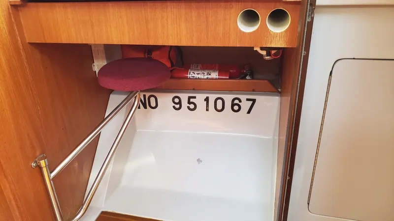 Slide: The Image of 1989 Hunter Legend 37 interior with storage compartment and fire extinguisher. - 30