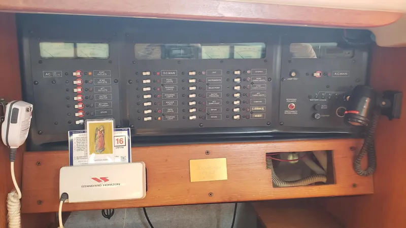 Slide: The Image of Control panel of a 1989 Hunter Legend 37 sailboat with various switches and equipment. - 31