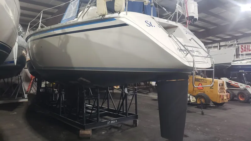 Slide: The Image of 1989 Hunter Legend 37 sailboat on dry dock in a warehouse setting. - 37