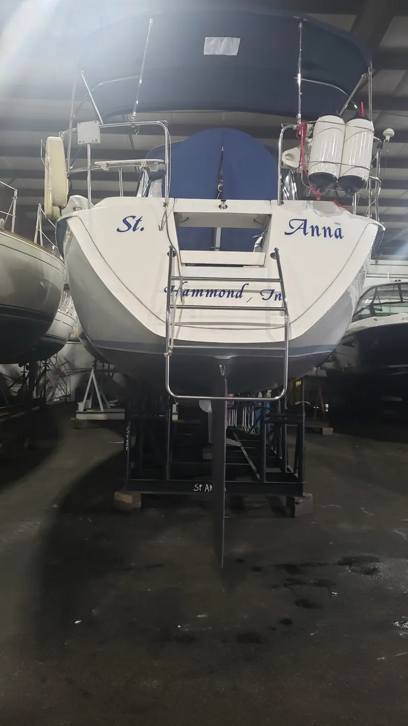 Slide: The Image of 1989 Hunter Legend 37 sailboat in storage, rear view with ladder and equipment. - 38