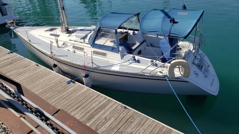 Slide: The Image of 1989 Hunter Legend 37 sailboat docked in calm marina waters. - 4